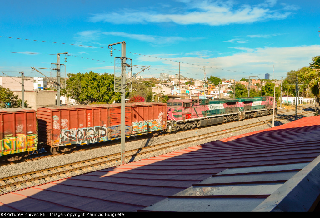 FXE AC4400 Locomotives leading a mixed freight train